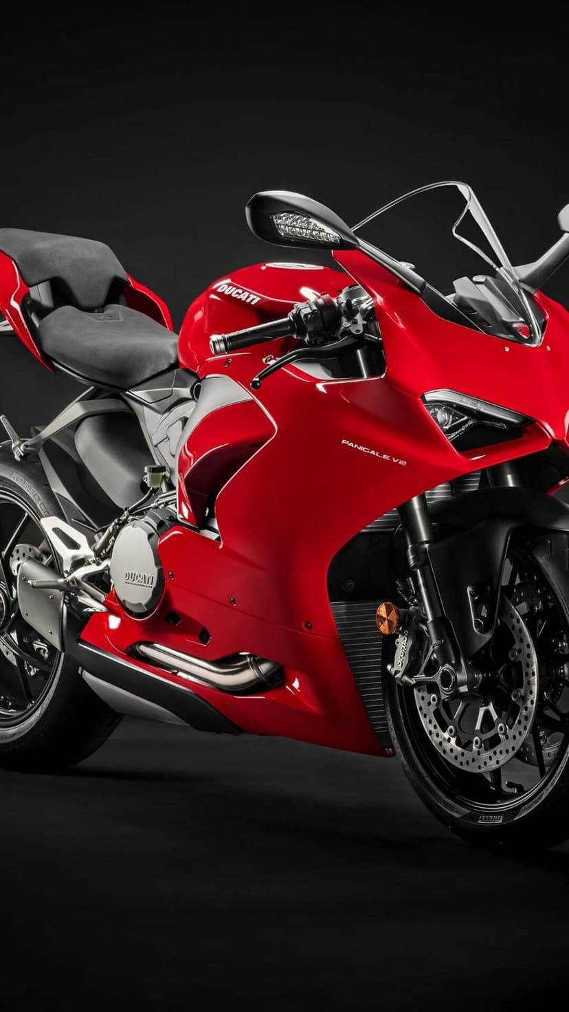 Red Ducati Panigale V2 motorcycle with sharp fairings, black wheels, and detailed mechanical engine components.