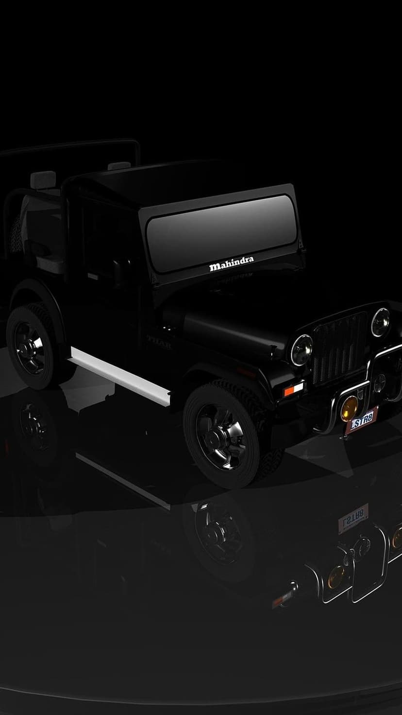 Mahindra Thar 4x4 with glossy black paint, signature grille, and round headlights against a dark backdrop.