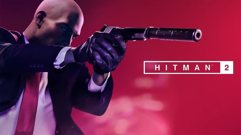 Agent 47 aims a silenced pistol against a vibrant red background in this Hitman 2 gaming scene.