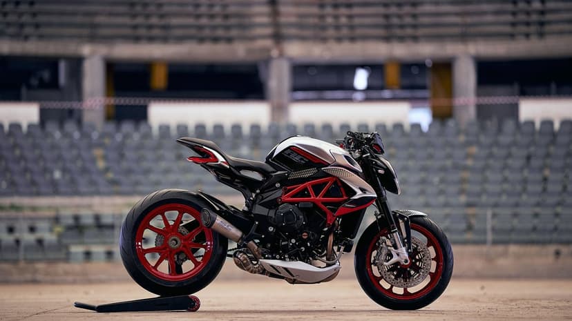 MV Agusta Dragster RC motorcycle with red trellis frame and wheels parked in a blurred stadium setting.