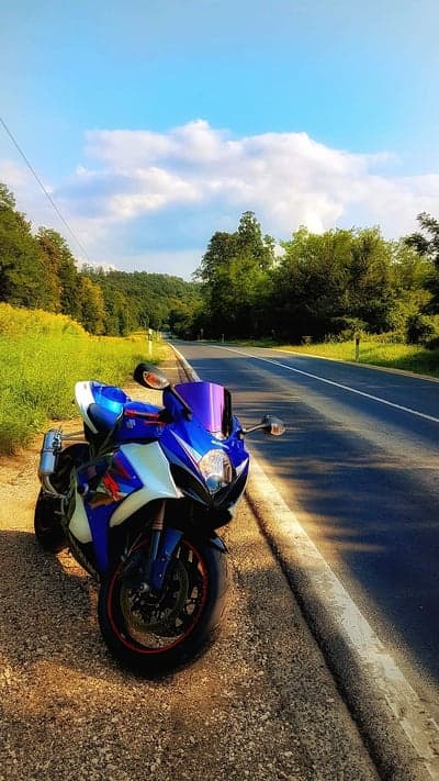 Motorcycle parked on the side of a scenic road