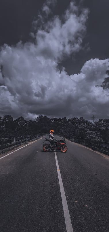 Moody Biker on Stormy Bridge Mobile Screen Backdrop