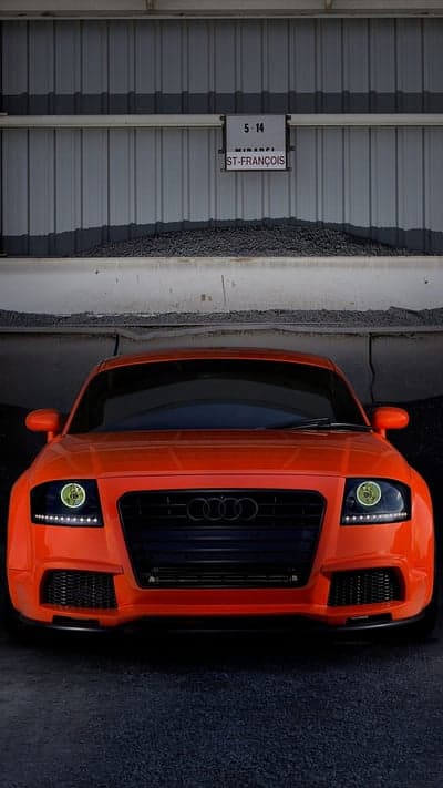 Vibrant Orange Audi TT in Industrial Setting