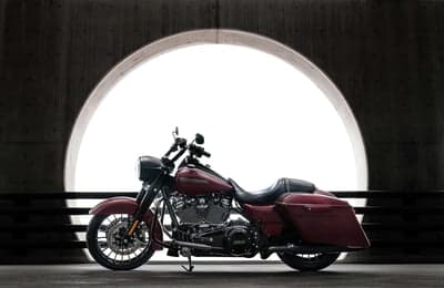 Red Harley-Davidson Cruiser Under Glowing Stone Archway