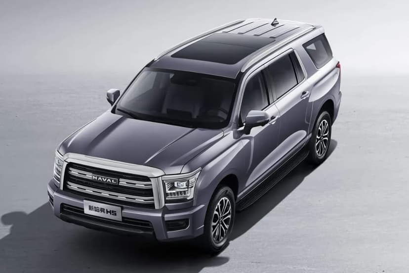 Metallic Haval H5 SUV with a chrome grille and panoramic sunroof on a neutral studio background.