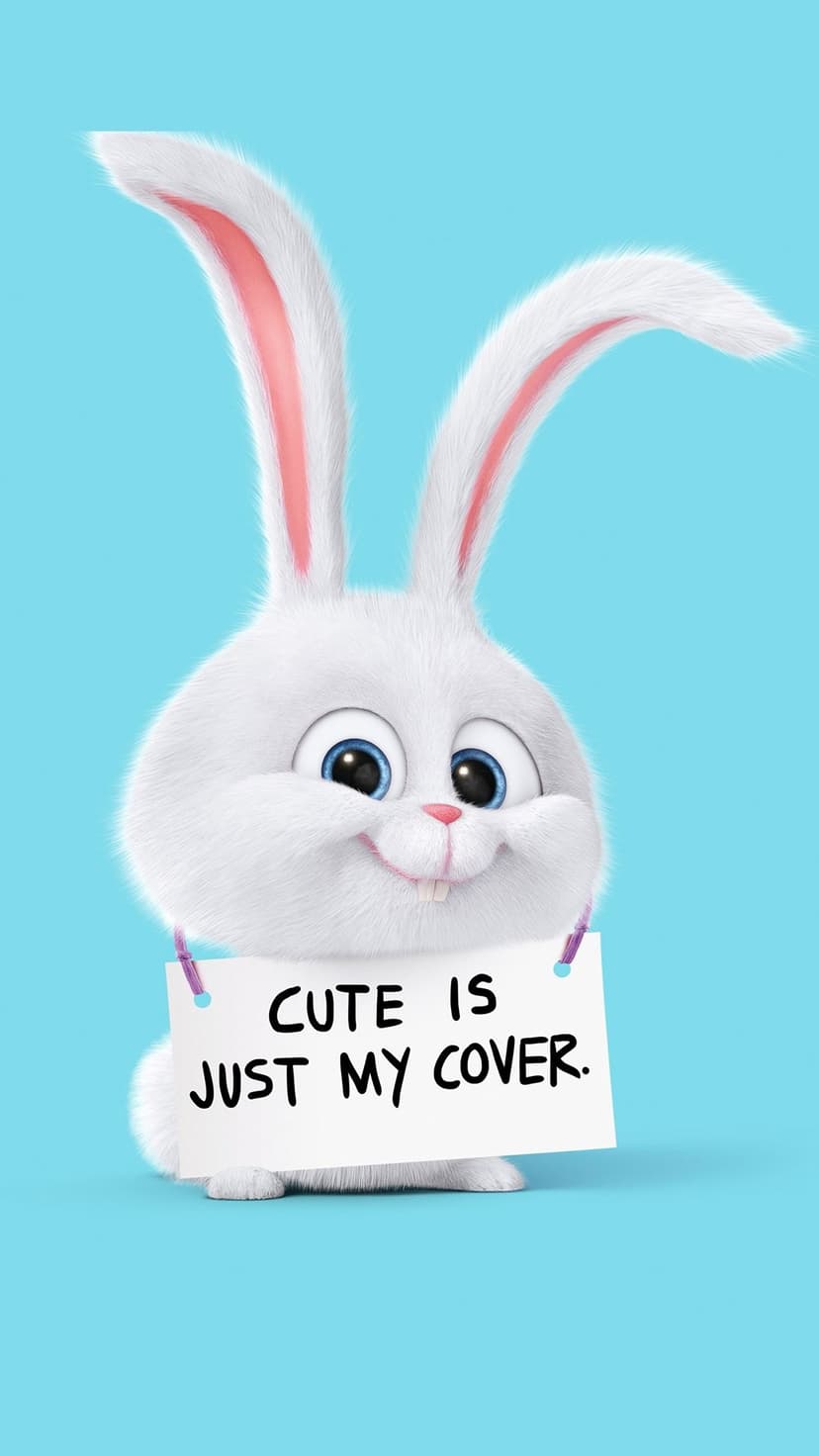 Snowball the rabbit holds a sign reading Cute is Just My Cover against a bright blue studio background.