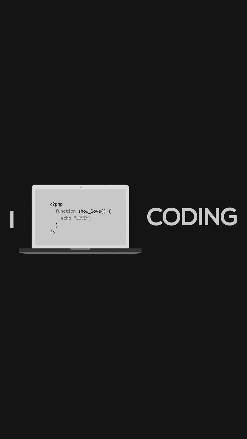 Laptop screen showing PHP code syntax alongside the word coding on a high-contrast pitch black backdrop.