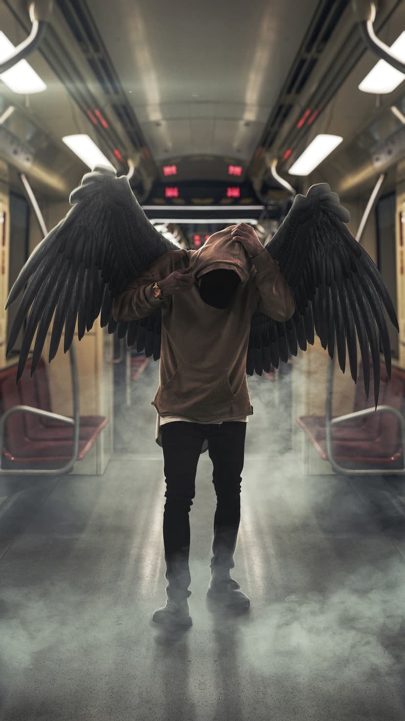 Hooded figure with large black wings stands inside a hazy subway car with hands covering their face.