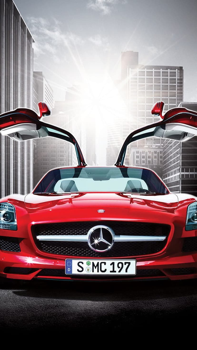 Red Mercedes-Benz SLS AMG with open gullwing doors parked amidst glass skyscrapers under a bright midday sun.