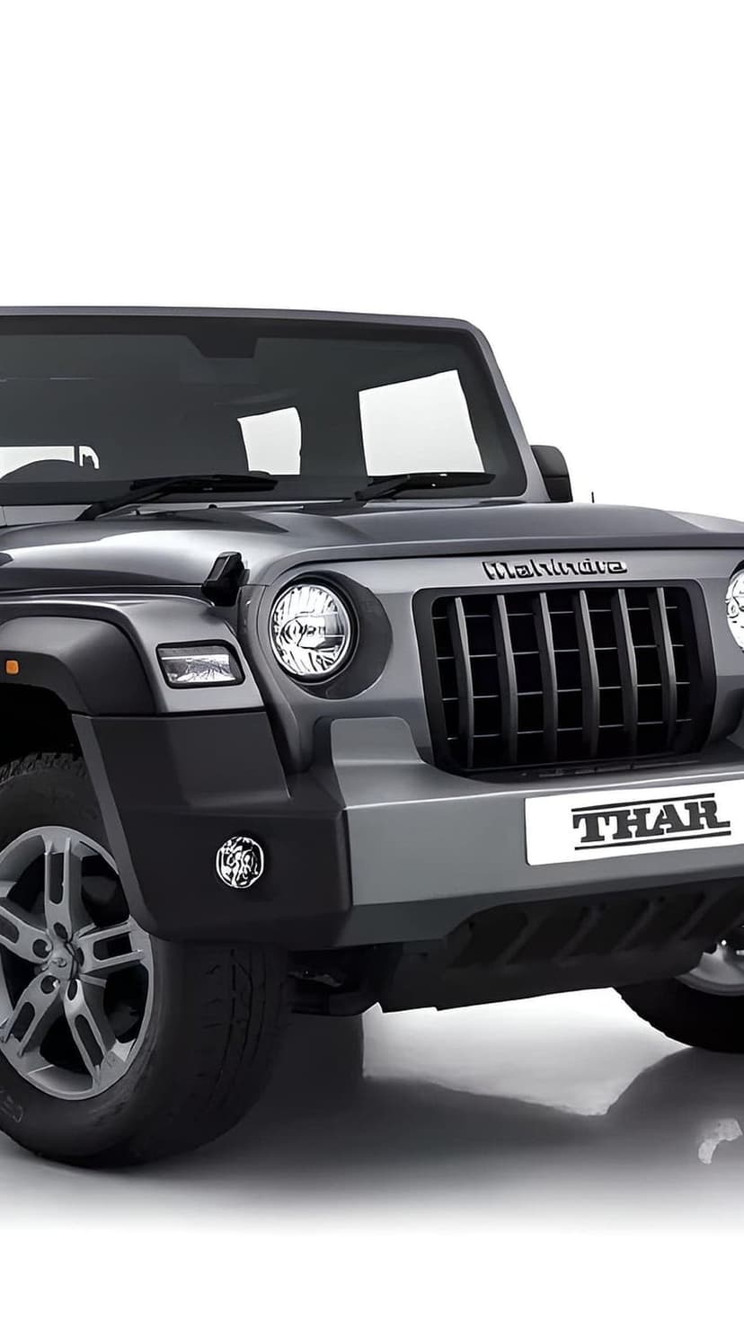 Mahindra Thar front grille with vertical slats, round headlights, and a silver badge on a white background.