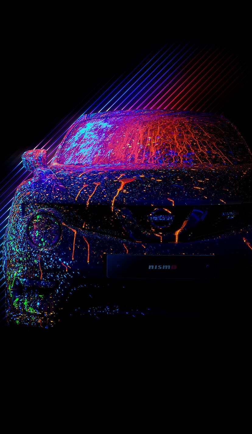 Nismo sports car covered in glowing neon paint splatters under ultraviolet light with diagonal light streaks.