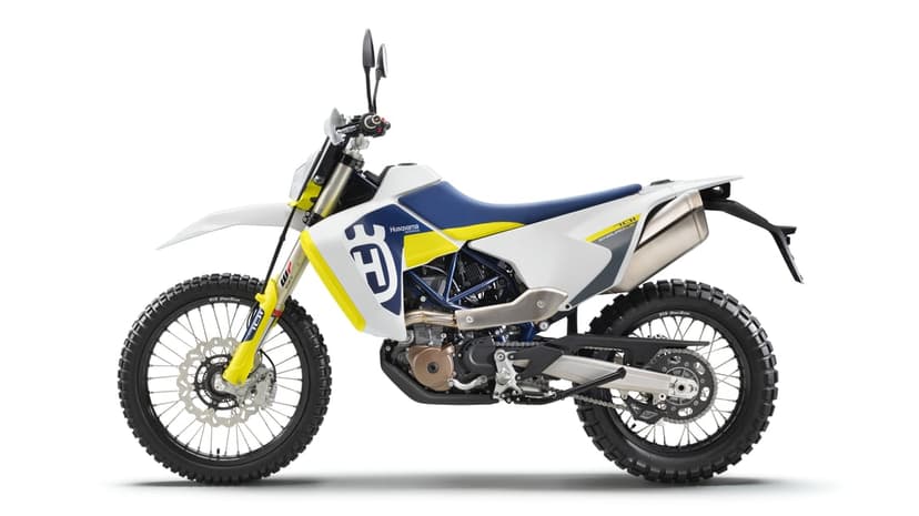 Side view of a white and blue Husqvarna 701 Enduro LR motorcycle with yellow accents on a white background.