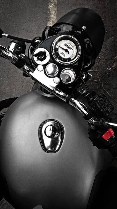Close-up of Royal Enfield motorcycle fuel tank and handlebars