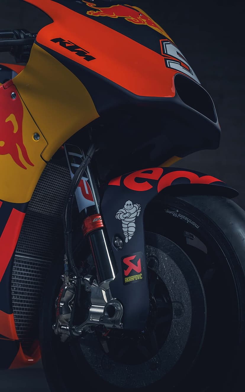 KTM racing motorcycle front fairing with Red Bull logos, orange suspension forks, and aerodynamic bodywork.