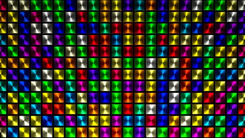 Shimmering multi-colored disco ball squares arranged in a precise grid with sharp metallic light reflections.
