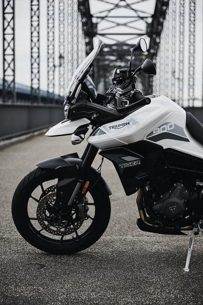 Triumph Tiger 900 motorcycle parked on a bridge