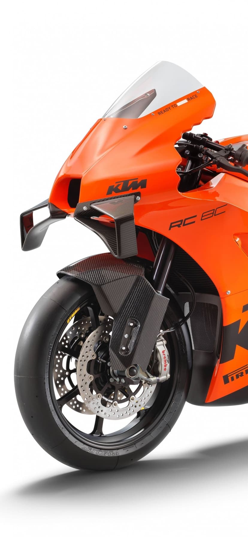 KTM RC 8C racing motorcycle with orange fairings, carbon fiber wings, and Brembo brakes on white.
