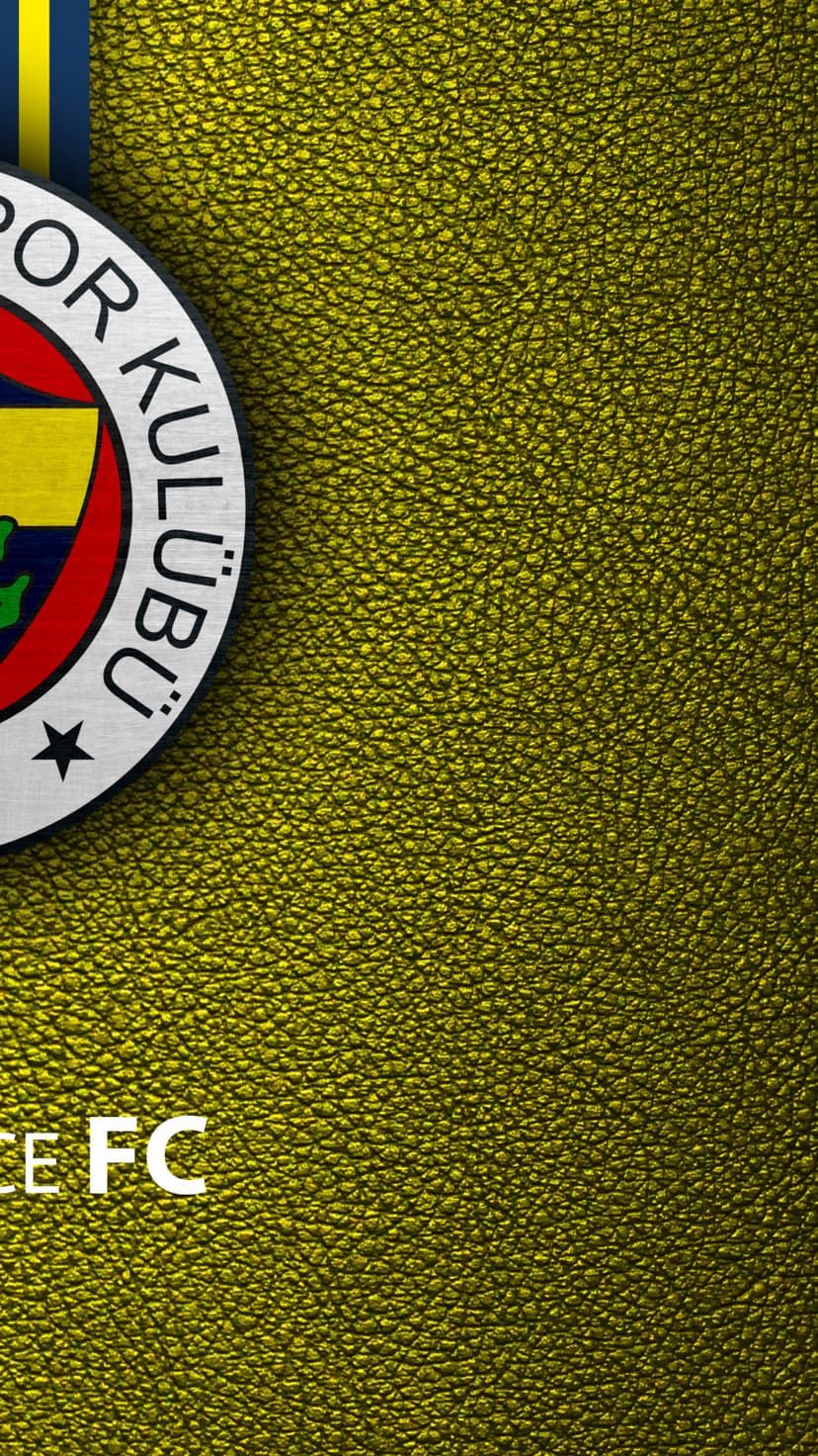 Fenerbahce SK football crest with a gold star rests on a metallic yellow leather textured surface in a close-up.