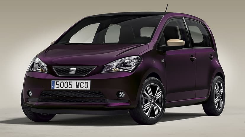Front three-quarter view of a dark purple SEAT Mii hatchback with gold mirrors in a neutral studio space.