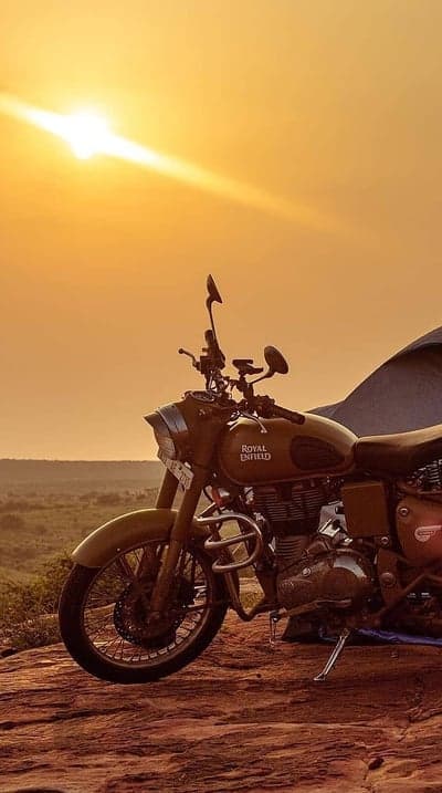 Royal Enfield Motorcycle at Sunset in Desert Landscape