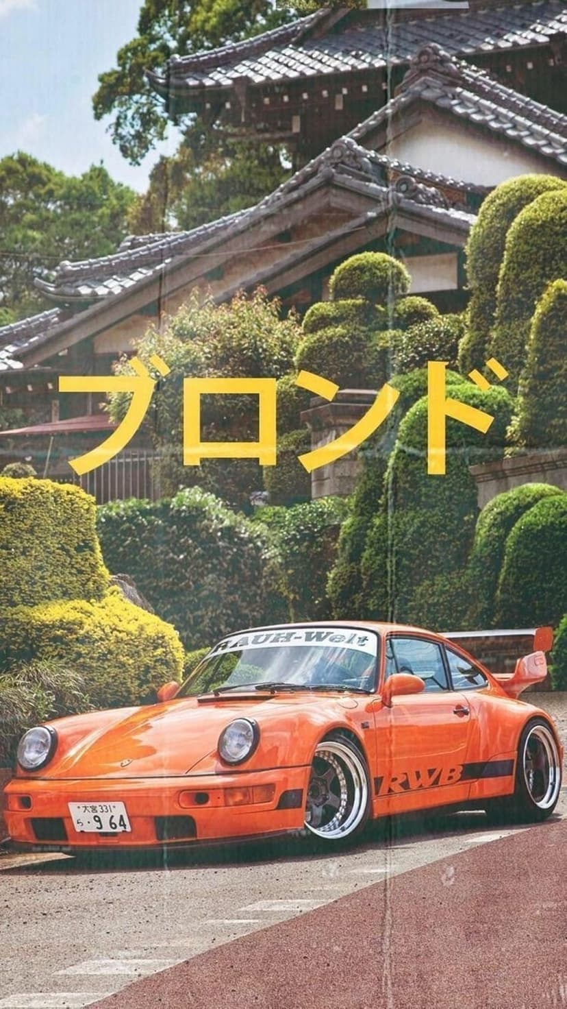 Orange RWB Porsche 911 with a widebody kit parked near a traditional Japanese pagoda and lush green trees.