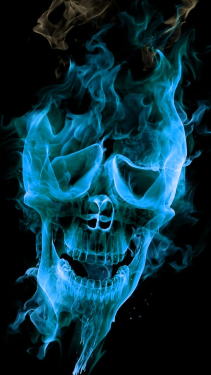 Skull formed from vibrant blue flames and swirling smoke against a solid black background with glowing embers.
