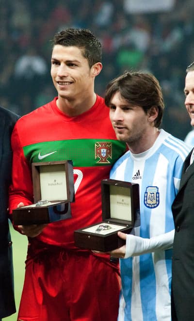 Ronaldo and Messi with watches on the pitch