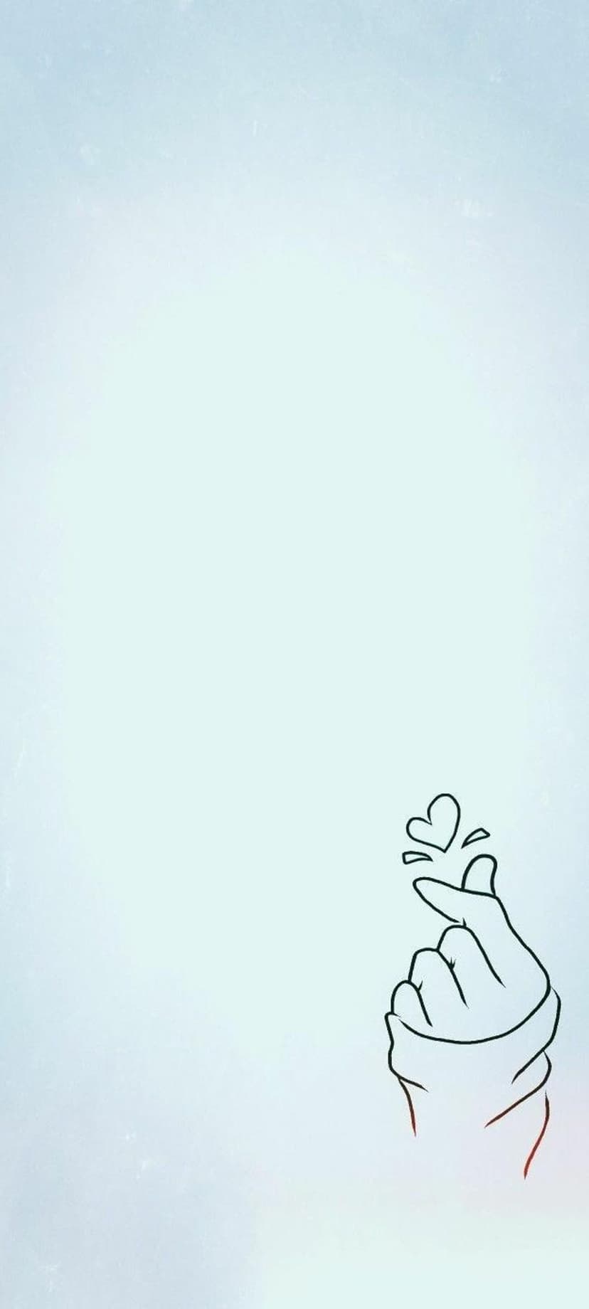 Human hand forming a finger heart symbol against a blurred light blue and white vertical gradient background.