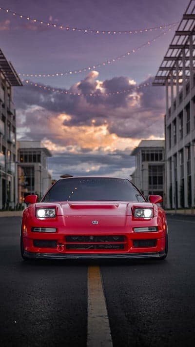 Red Acura NSX Sports Car Under Twilight Streetlights
