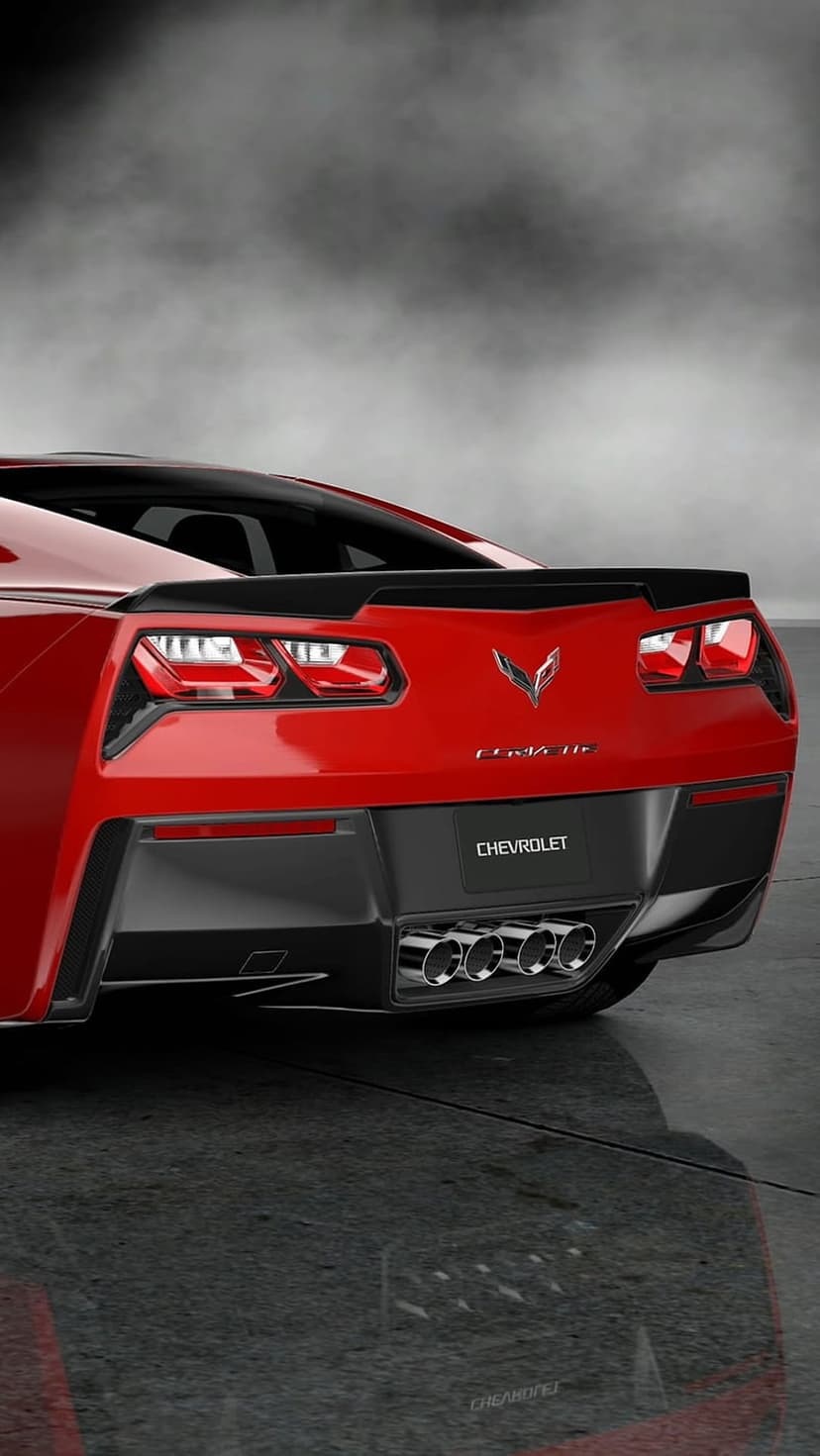 Red Corvette Stingray rear bumper with four chrome exhaust tips and a silver emblem on reflective concrete.