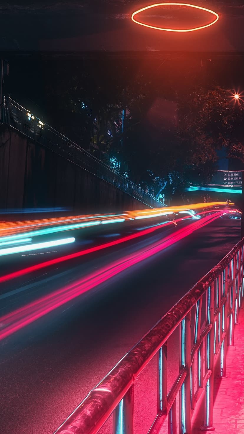 Vibrant red and blue light trails move toward a floating orange ring in a dark, futuristic urban underpass.
