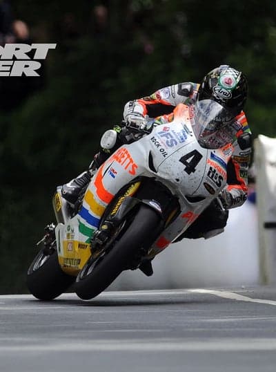 Motorcycle Racer Leans into Turn at High Speed