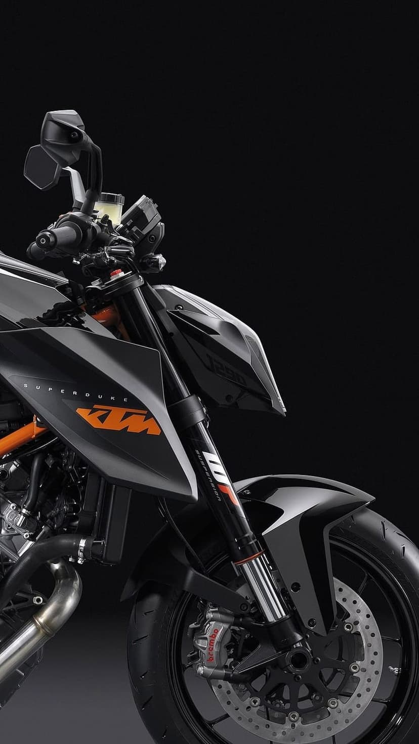 KTM 1290 Super Duke R motorcycle front section featuring orange branding, WP suspension, and Brembo brake calipers.