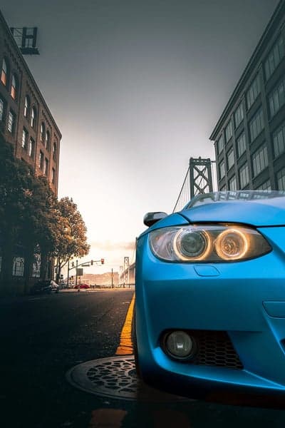 Electric Blue Supercar on Urban Street Mobile Wallpaper
