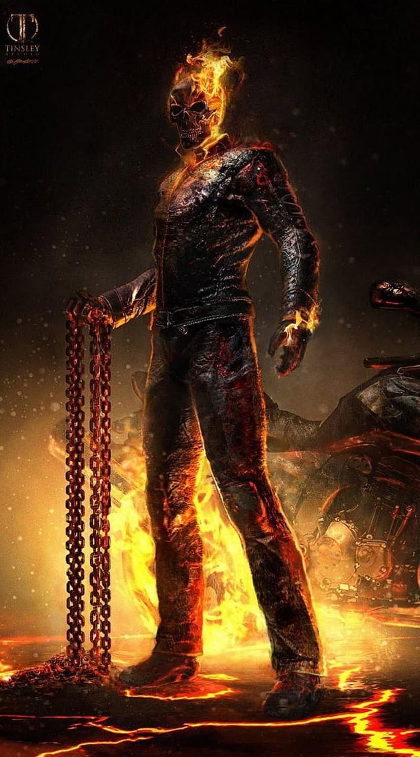 Ghost Rider with a flaming skeletal head holds heavy chains while standing before a motorcycle in fire.
