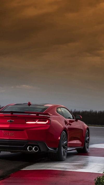 Red Chevy Camaro Braking on Wet Track Mobile Background