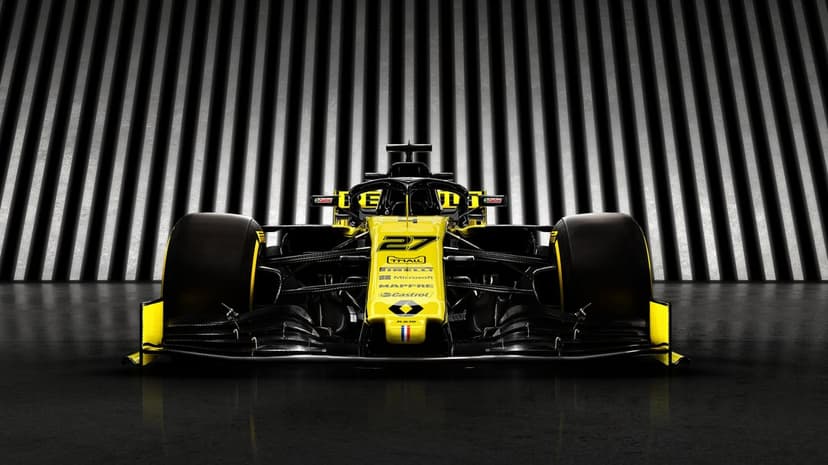 Front view of a yellow and black Renault F1 car with racing number 27 against a striped studio background.