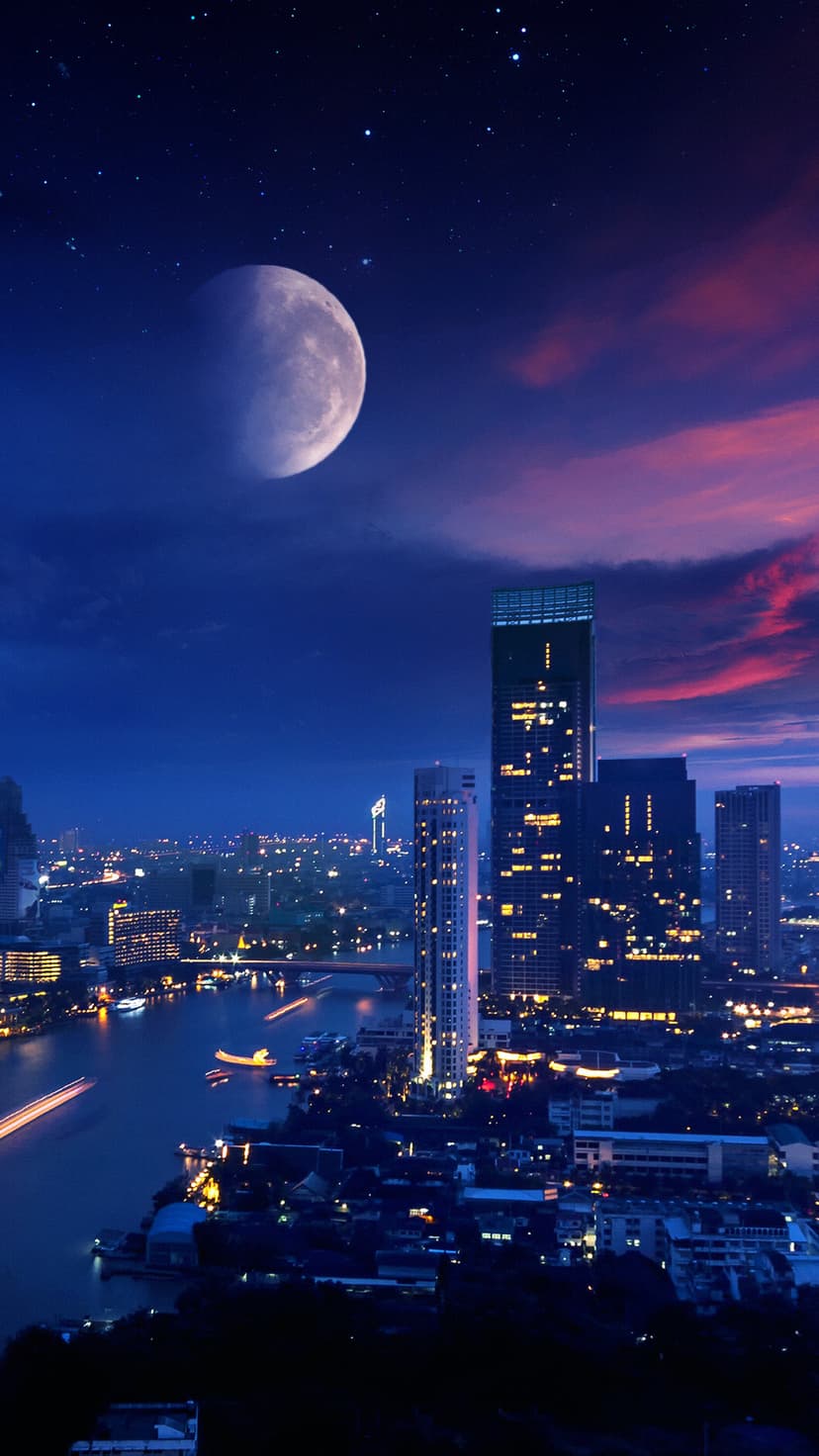 Radiant moon glows above a purple metropolis featuring lit skyscrapers and a winding river under a starry sky.