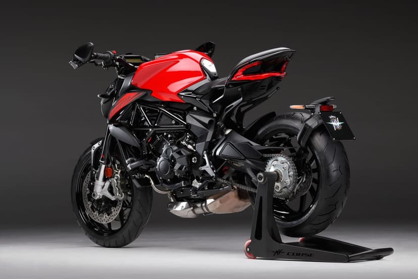 Red and black MV Agusta Dragster motorcycle on a paddock stand against a dark grey studio background with soft light.