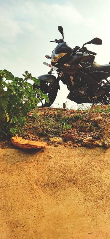 Aggressive Black Sportbike on Rugged Dirt Path Phone Wallpaper