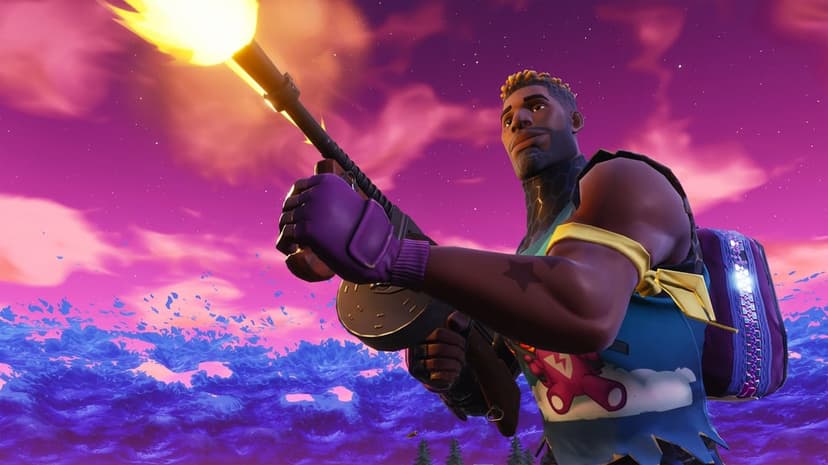 Fortnite character firing a drum gun with a bright muzzle flash against a purple and pink sunset sky.