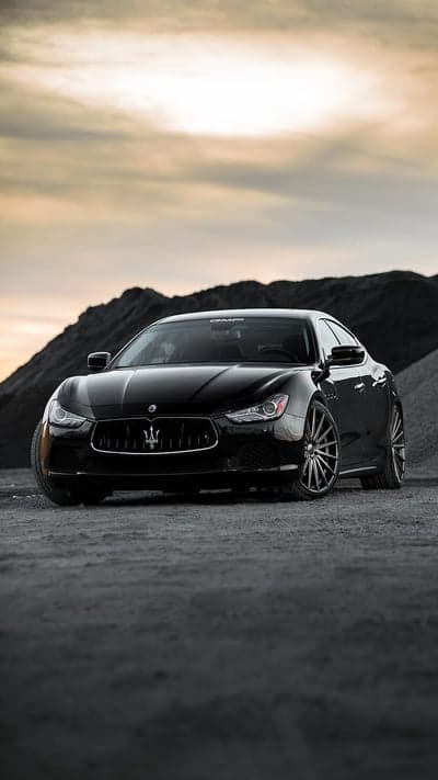 Sleek Black Maserati Ghibli on Gravel Road