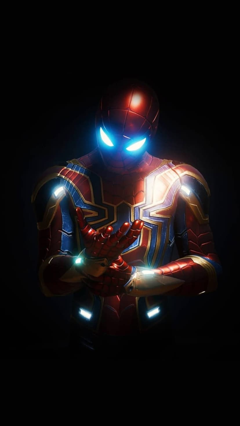 Iron Spider-Man with glowing blue lenses wearing red and gold nano-tech armor against a dark shadowed backdrop.
