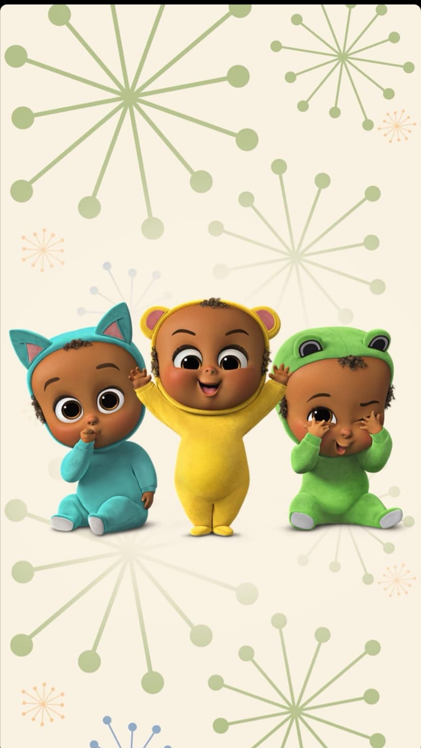 Three dark-skinned babies in frog, bear, and cat onesies stand on a cream background with starburst patterns.
