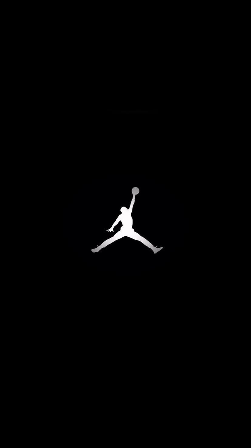 White Jumpman logo silhouette of a basketball player in mid-air against a solid black portrait background.