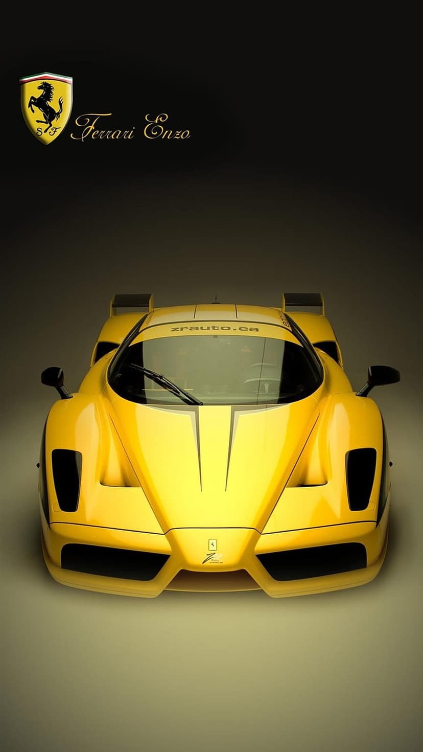 Yellow Ferrari Enzo sports car front view featuring the prancing horse emblem and windshield text on the glass.