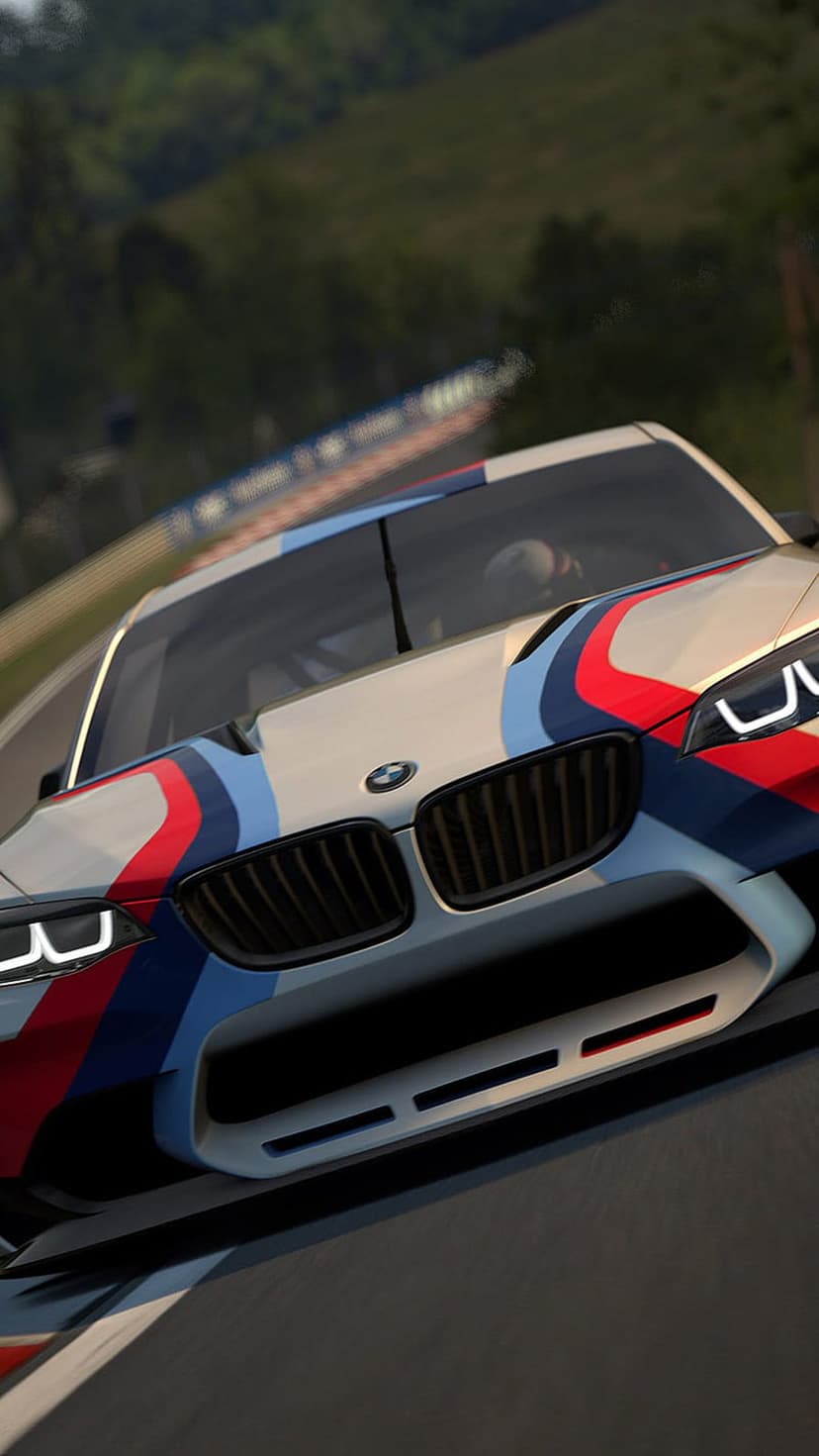 BMW M4 DTM Champion Edition racing car with tri-color livery on a track, featuring a low-angle front view.