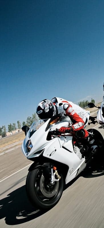Racer on a White Motorcycle Leaning into a Turn
