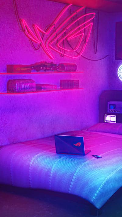 Neon ROG Gamer Room with Laptop on Bed