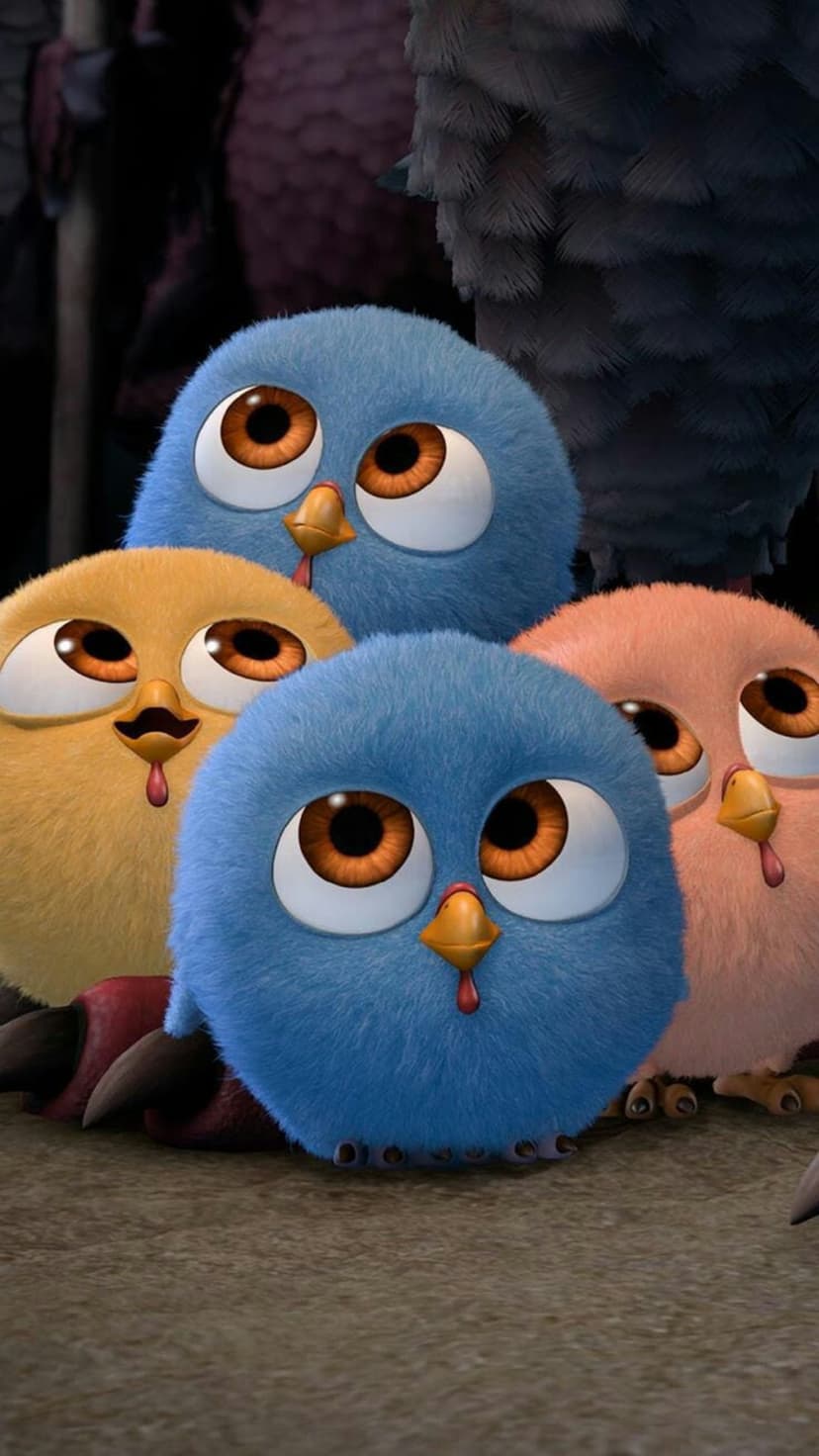 Four fluffy Angry Birds hatchlings with large expressive eyes huddle together in a vibrant colorful group.
